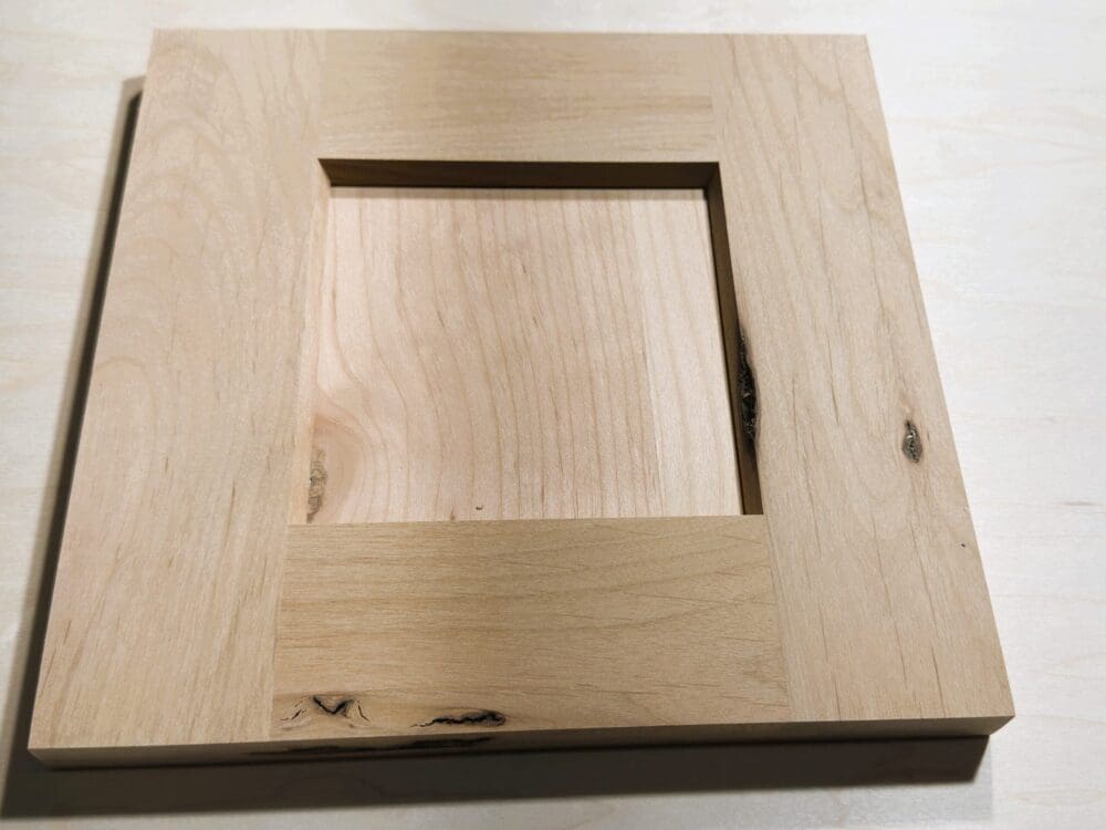 Flat-panel door sample with bevel inside-edge profile in knotty alder