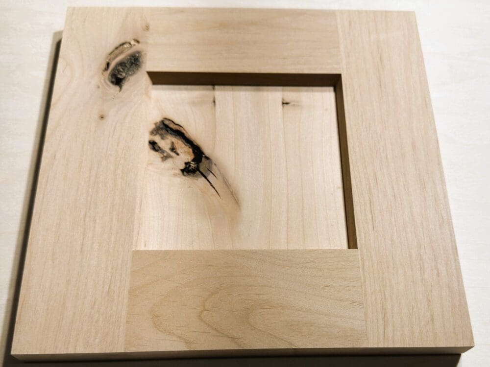 Reverse back-cut raised-panel door sample with bevel inside-edge profile in knotty alder